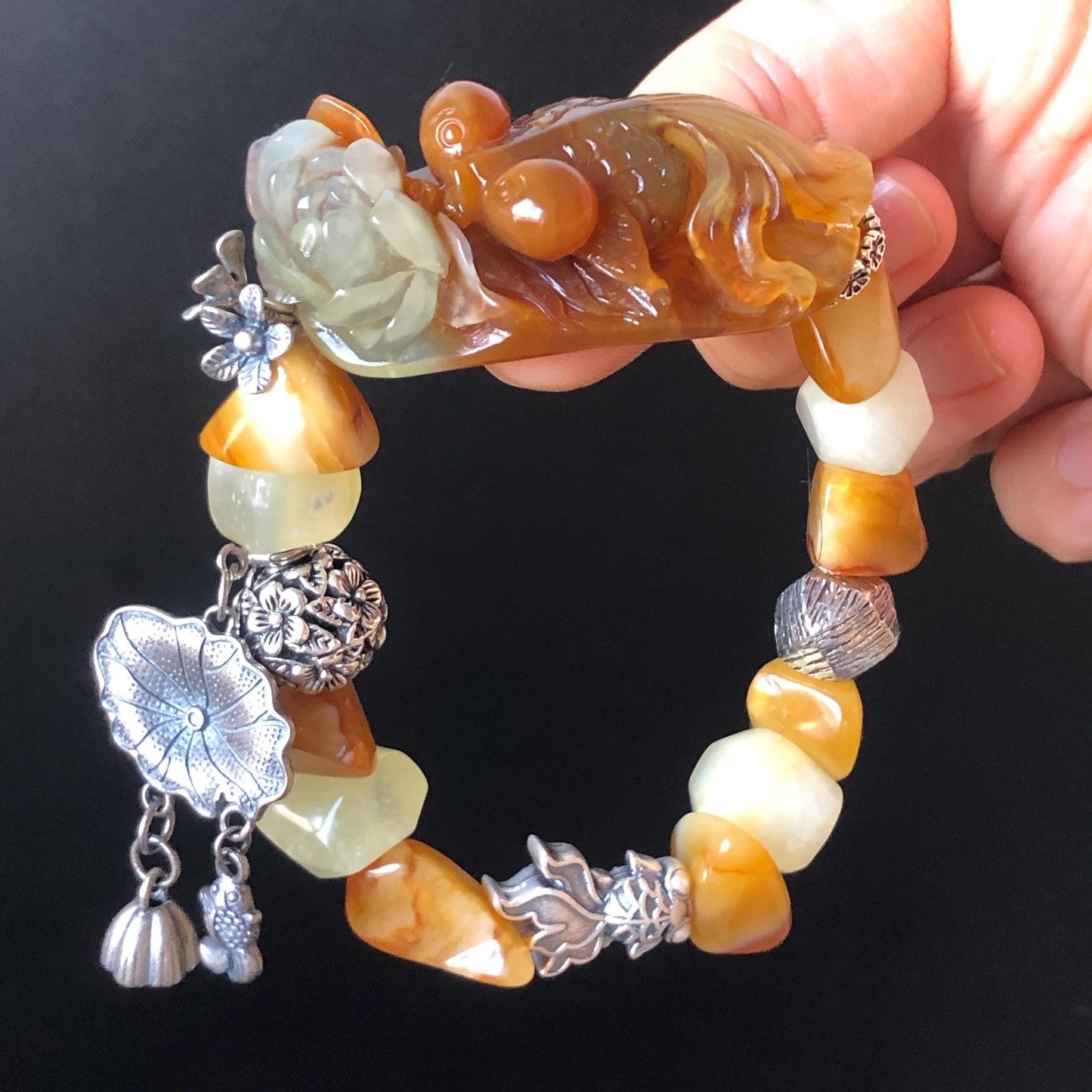 Xiu Jade Serpentine Carved Goldfish Lotus Charm with Irregular Bead Bracelet | Orange Jade | 925 Sterling Silver & Vintage Tibetan Silver accessory hand carved jade carving hand engraved jade bracelet elastic bracelet orange jade bracelet carved goldfish carving engraved lotus carving gift for her duy bracelet natural jade untreated jade dangle bracelet charm bracelet gift for her